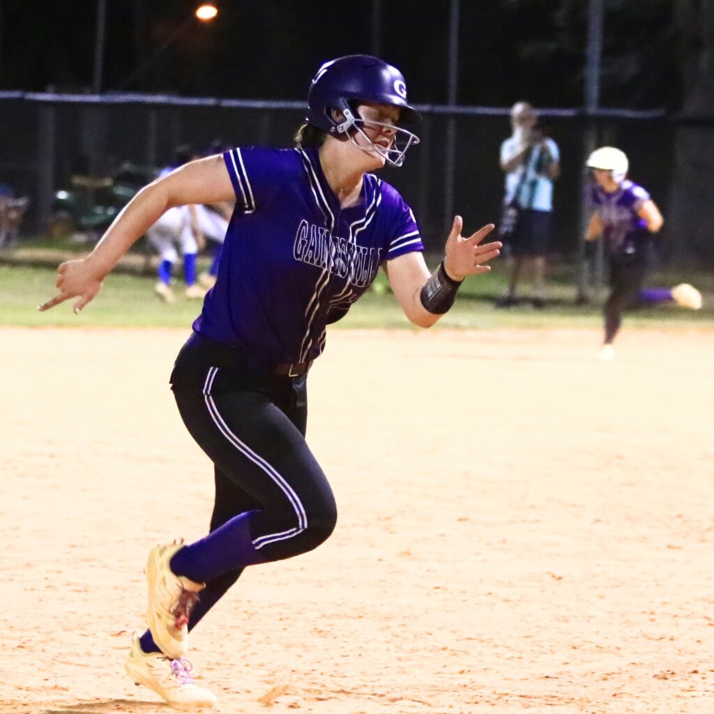 Gainesville's Adriana Koralewski (16) hustles on her way home for a 6-4 lead in the sixth inning against Deltona in the 5A-District 5 championship game. Photo by C.J. Gish