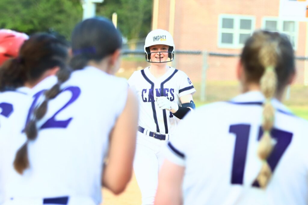 Gainesville's Leanna Bourdage is greeted by teammates at home plate after hitting a two-run first-inning home run against Deltona in the Class 5A-Region 2 Quarterfinal. Photo by C.J. Gish