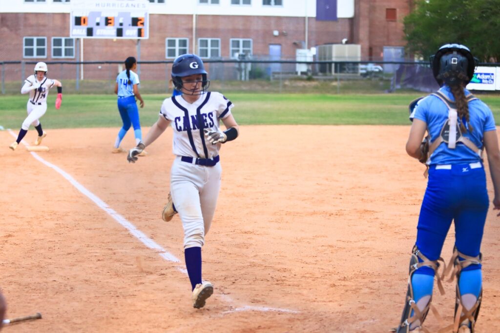 Gainesville's Roxanne Walsh (5) and Leanna Bourdage (14) score in the third inning for a 4-0 lead against Deltona in the Class 5A-Region 2 Quarterfinal. Photo by C.J. Gish