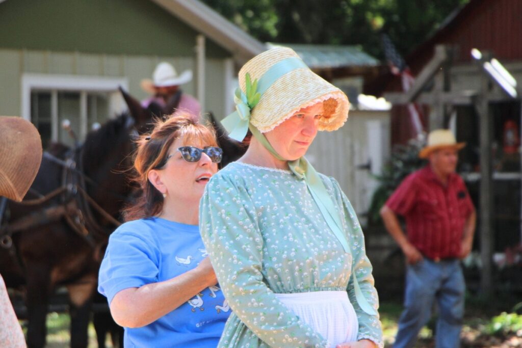 Hair head Rita Parillo (left) gives touch ups before cameras roll. Photo by Lillian Hamman
