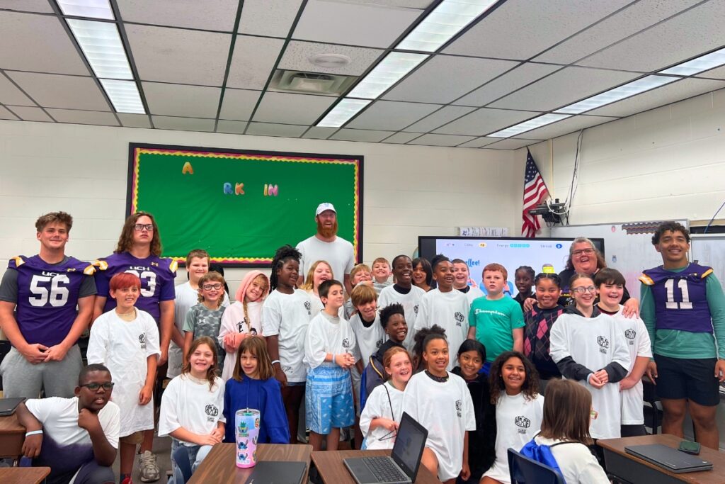 Hayden Hurst poses for a photo with a third grade class at Lake Butler Elementary School and members of the Union County High School football team. Photo by Nick Anschultz