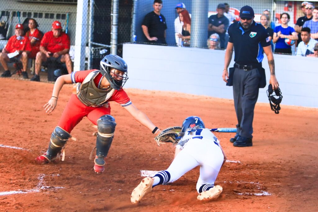 Santa Fe catcher Ainslea Kelsoe gets the third out in the top of the fourth inning with a tag at home plate against Eustis in the 3A-Region 2 Final. Photo by C.J. Gish