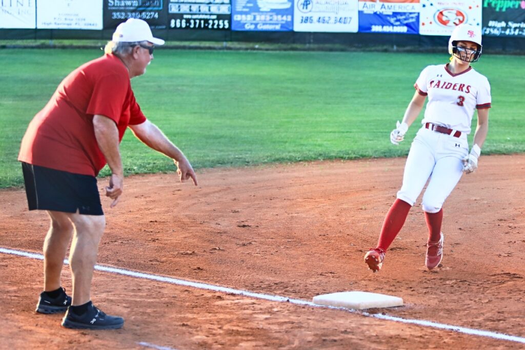 Santa Fe's Callie Blair (3) reaches third base after an overthrow to first in the fourth inning against Mount Dora in the Class 3A-Region 2 Quarterfinals. Photo by C.J. Gish