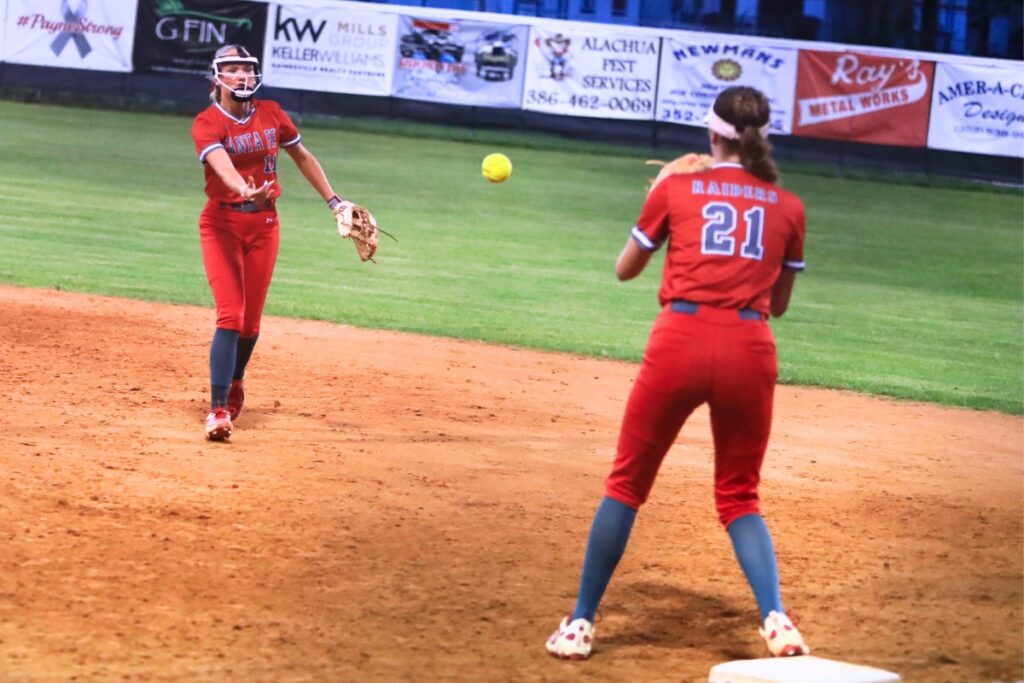 Santa Fe's Juliana Mott (11) tosses the ball to Ryleigh Davis (21) for the third out in the top of the seventh inning against Eustis in the 3A 3A-Region 2 Final. Photo by C.J. Gish