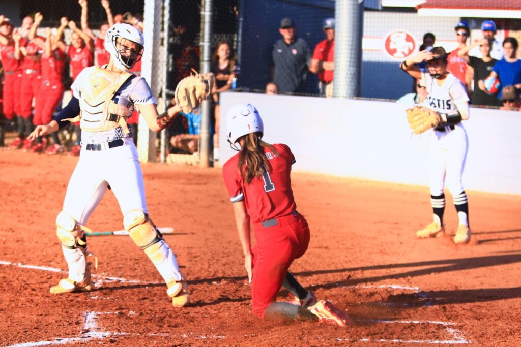 Santa Fe's Maren Hornsby (1) slides into home plate for a first-inning score against Eustis in the 3A-Region 2 Final. Photo by C.J. Gish