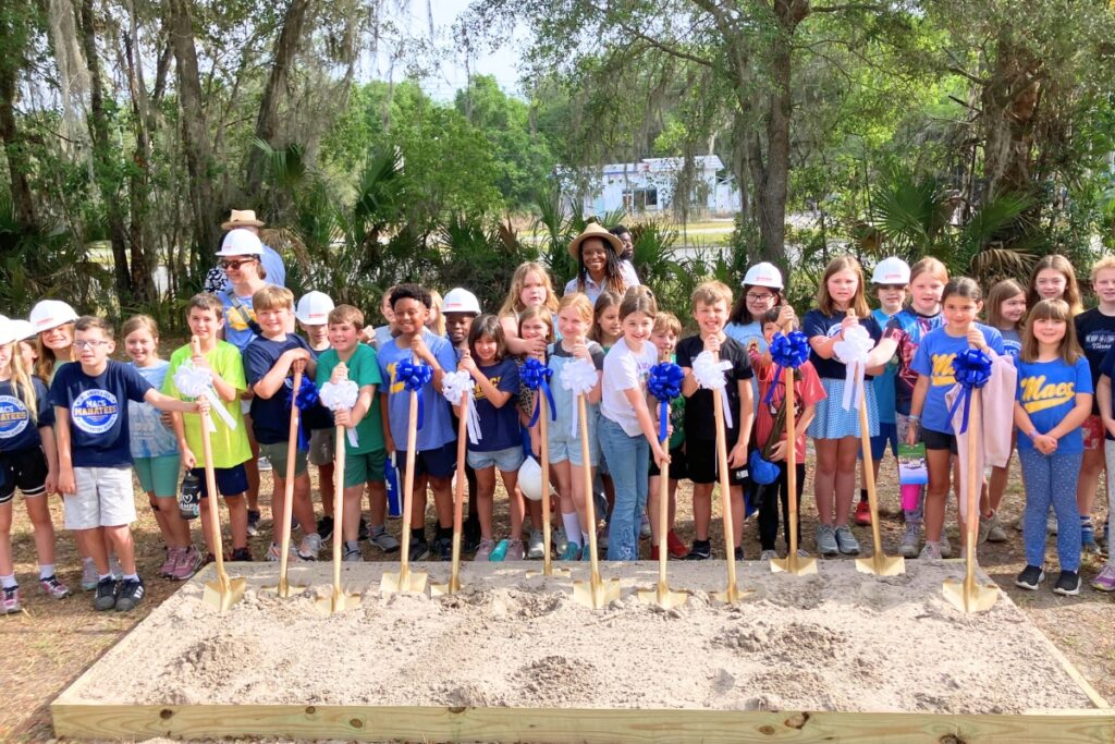 Students from Micanopy Area Cooperative School and Micanopy Academy help break ground on the town's new library. Photo by Lillia