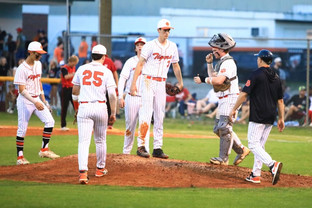 Trenton coach Chris Marlo has a meeting on the mound in the top of the fourth inning against Williston in the Rural Region 2 Finals. Photo by C.J. Gish