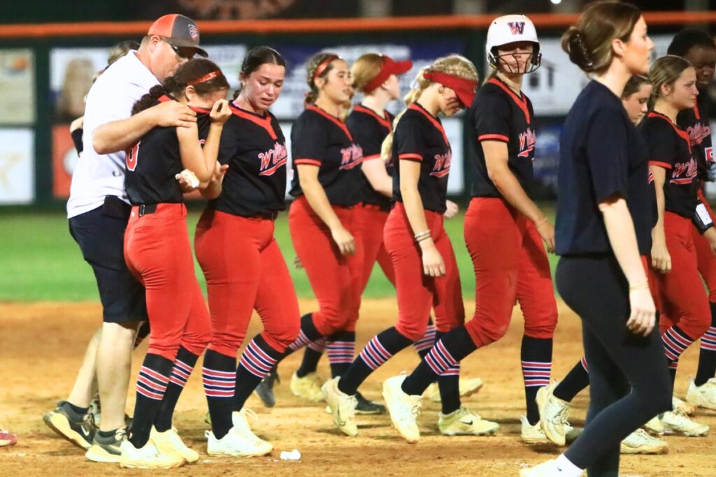 Trenton coach Kevin Benson (left) consoles Williston's Luna Asencion after a 2-1 Tigers' win in the Rural-Region 4 Final. Photo by C.J. Gish