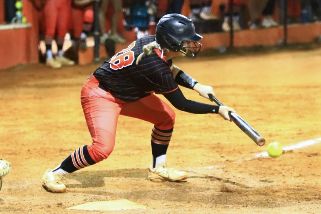 Trenton's Khloe Kirby (28) lays down a bunt in the bottom of the sixth inning against Williston in the Rural-Region 4 Final. Photo by C.J. Gish
