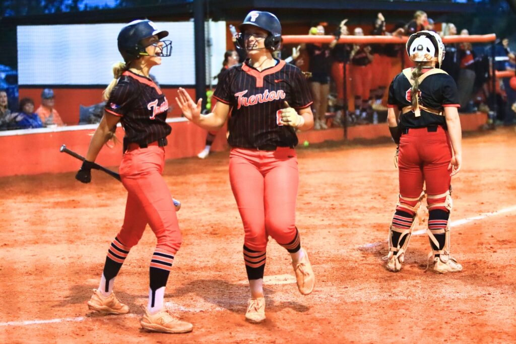 Trenton's Montana Moen (8) scores for a 2-1 lead in the bottom of the fifth inning against Williston in the Rural-Region 4 Final. Photo by C.J. Gish