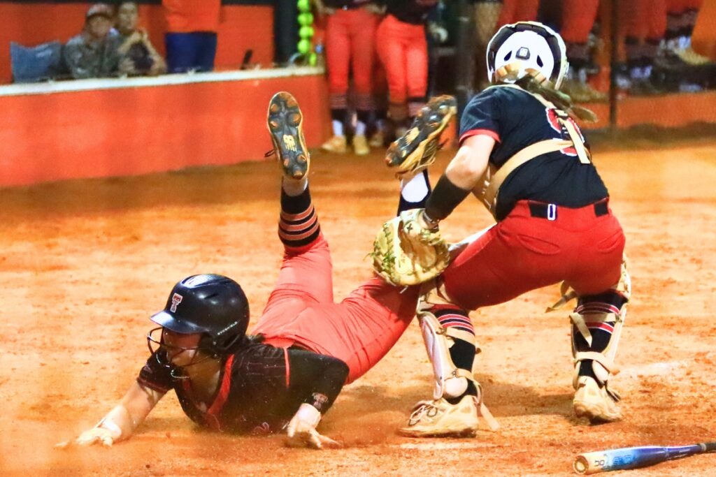 Trenton's Presley Akins gets tagged out in the bottom of the fifth inning by Williston catcher Brooklyn Bertrand in the Rural-Region 4 Final. Photo by C.J. Gish
