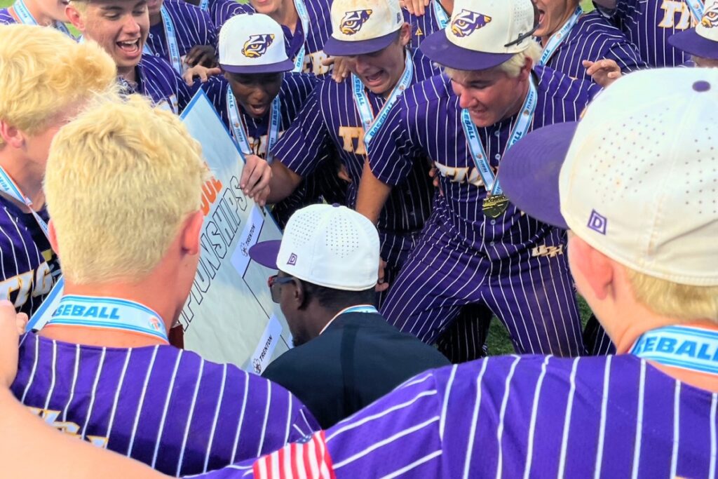 Union County coach Jiwan James places his team's name on the Rural baseball state championship board after a 10-9 win over Trenton on Thursday. Photo by Mike Ridaught