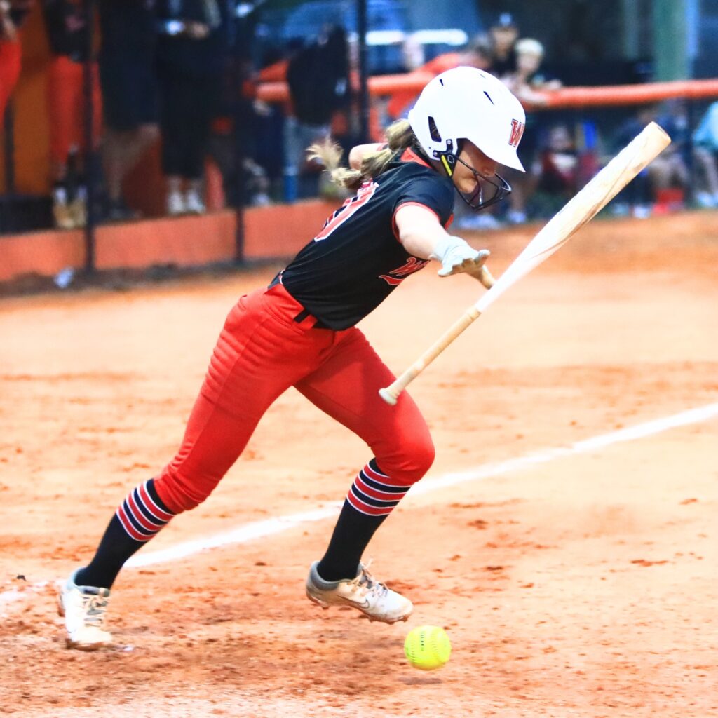 Williston's Dixie Adams (00) lays down a bunt in the top of the fifth inning against Trenton in the Rural-Region 4 Final. Photo by C.J. Gish
