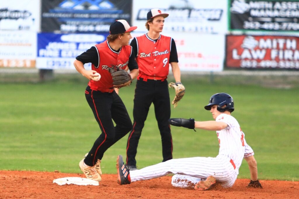 Williston's Harlan Cole turns a double play to end the bottom of the second inning against Trenton in the first game of the Rural-Region 4 Finals. Photo by C.J. Gish