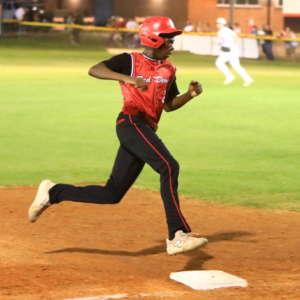 Williston's Jamarien Wilcox (2) rounds third base on his way home to in the top of the fifth inning against Trenton in the first game of the Rural-Region 4 Finals. Photo by C.J. Gish