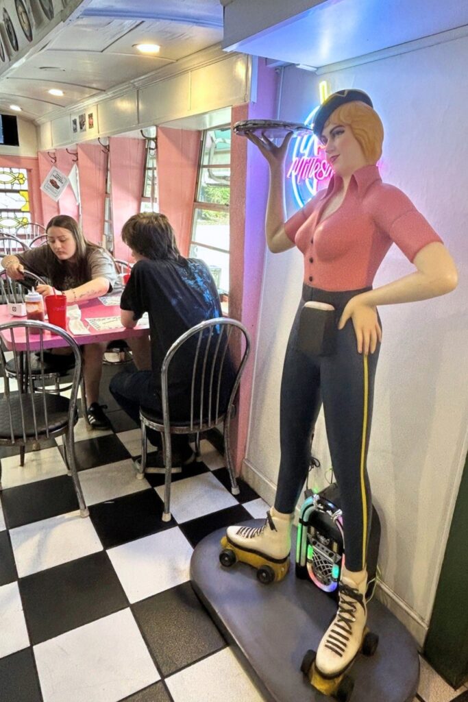 A statue of a carhop stands near one of the entrances at Angel’s Diner. Photo by Ronnie Lovler