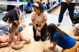 Elementary students receive hands-on CPR instruction at Hidden Oak Summer Camp