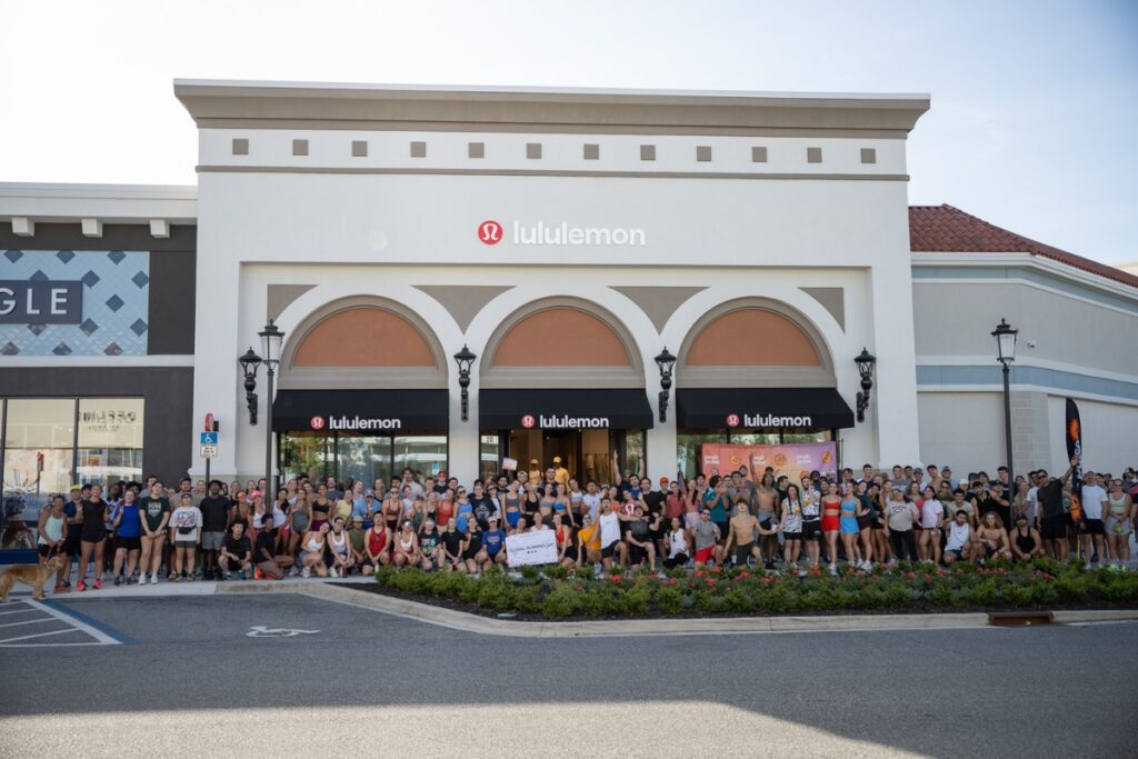Around 200 runners pose for a group photo before starting their 2-mile run in collaboration with Peak Pulse in Gainesville. This event is built around movement, community, and good energy.