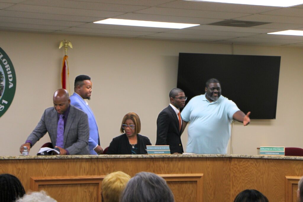 Commissioner Raymond Cue showed Ronald Cobb II and Jonathan Franklin to their new seats on the dais. 
