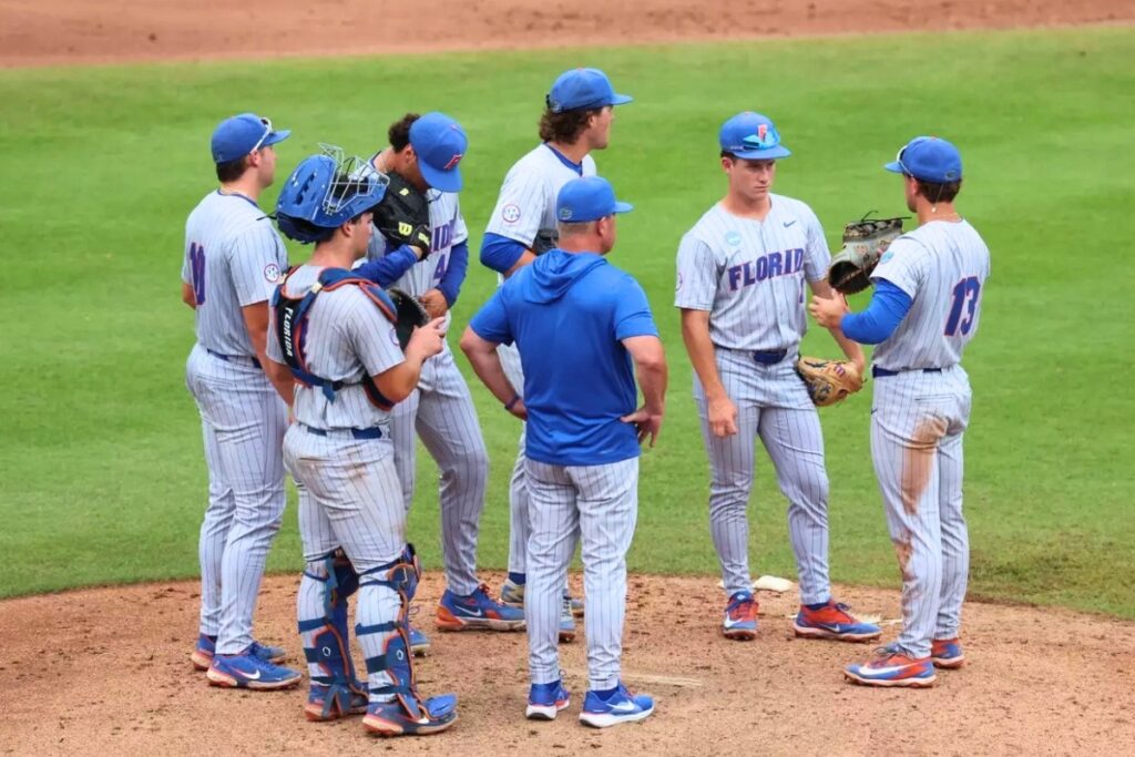 Florida head coach Kevin O'Sullivan and the infield gather on the mound during a pitching change in Sunday's 16-11 loss to Troy. Photo by Hannah White-UAA Communications