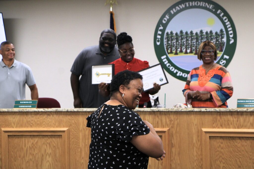 Hawthorne Mayor Jacquelyn Randall surprised City Clerk LaKesha McGruder (center) with key to the city for 26 years of service. Photo by Lillian Hamman