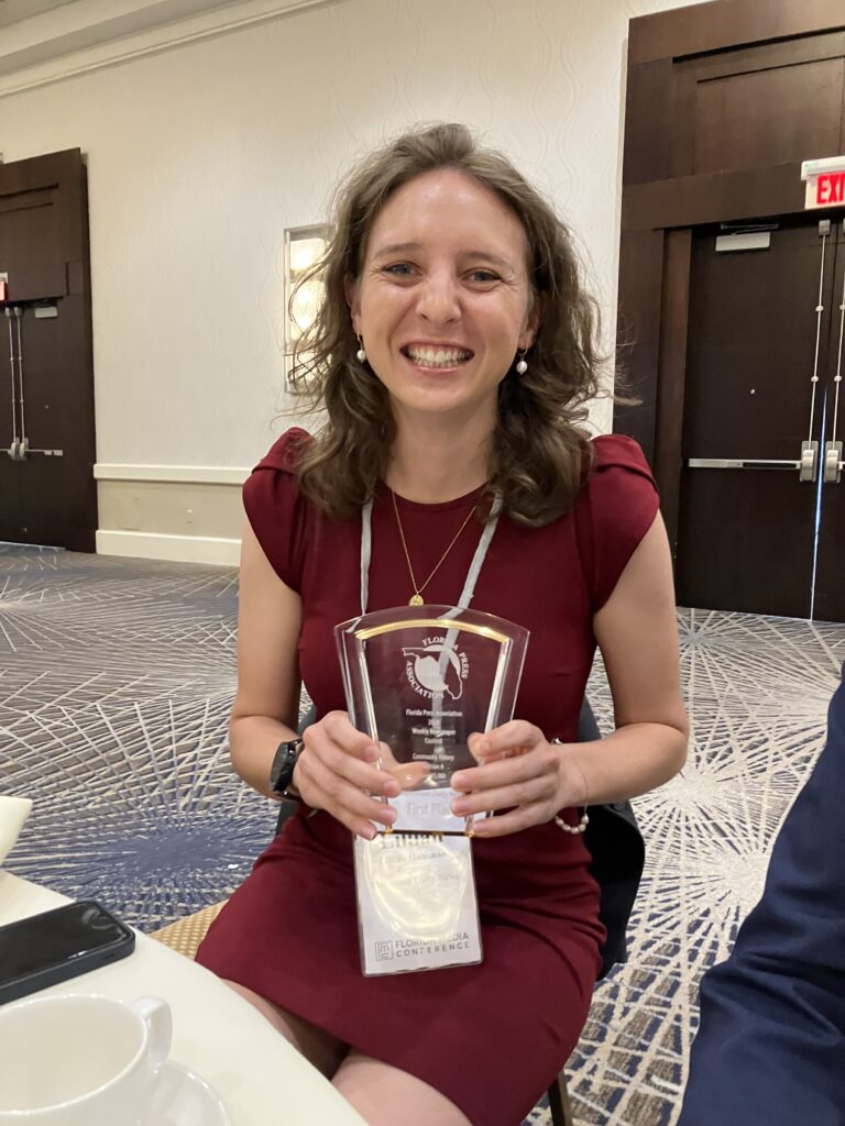 Lillian Hamman smiles with her first place award Friday at the Florida Media Conference.