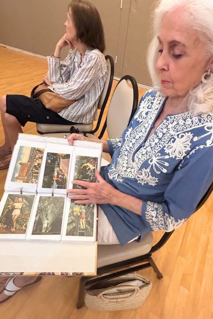 Lorian Welsh shows off some of her postcards. Photo by Ronnie Lovler