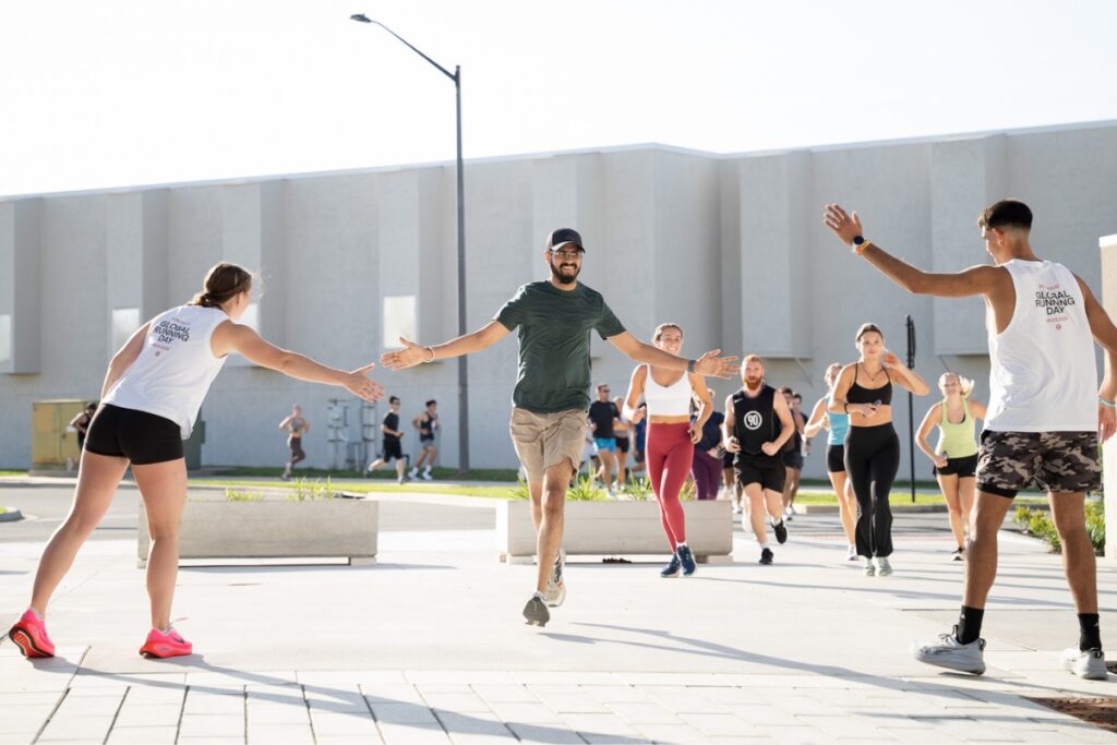 Runners celebrating after completing a 2-mile run in collaboration with Peak Pulse around Butler Plaza in Gainesville on Wednesday. Photo by Tim Rodriquez