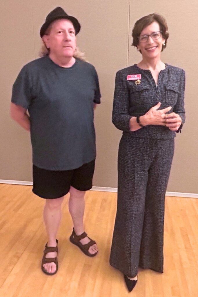 Speaker Liz Coursen poses with postcard aficionado Glenn Fischer after her talk. Photo by Ronnie Lovler