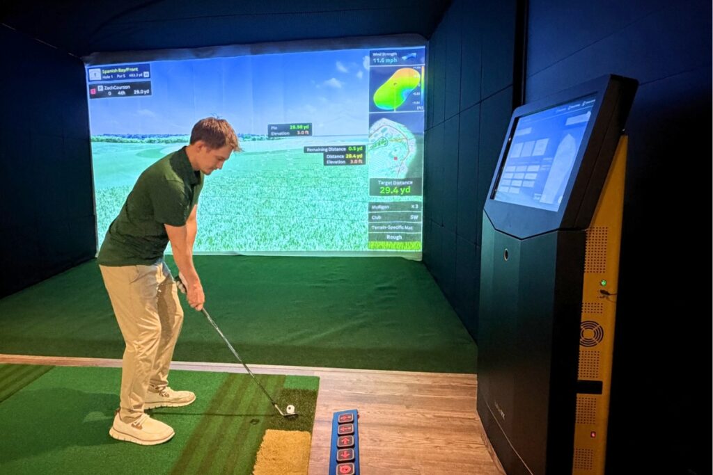 Stephen Courson hitting ball at the new Fairway Bays virtual golf simulation business that will open on June 22. Photo by Mike Gilland