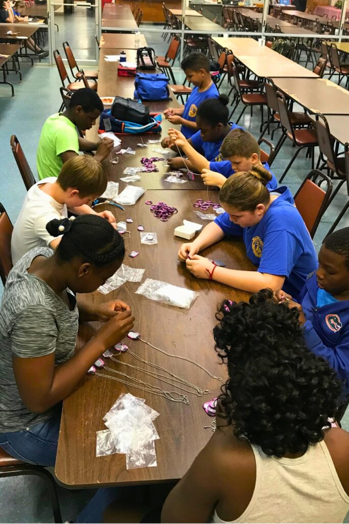 The Milton Lewis Young Marines help assemble dog tags to hand out at Newberry's Fourth of July parade. Courtesy James Islam