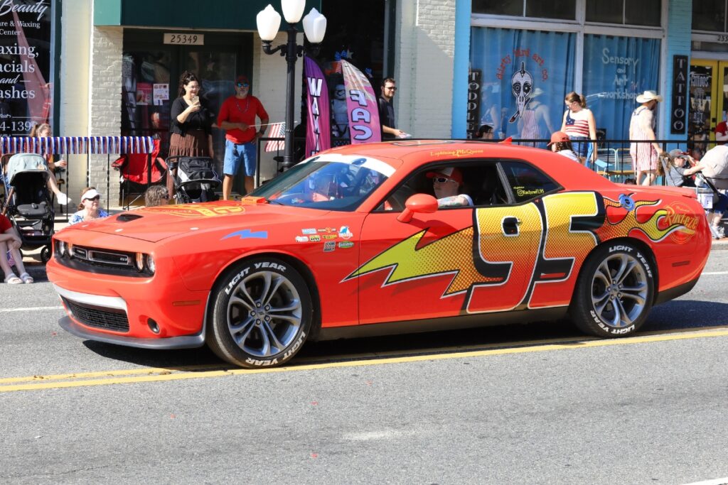 A Lightning McQueen car in the parade. 