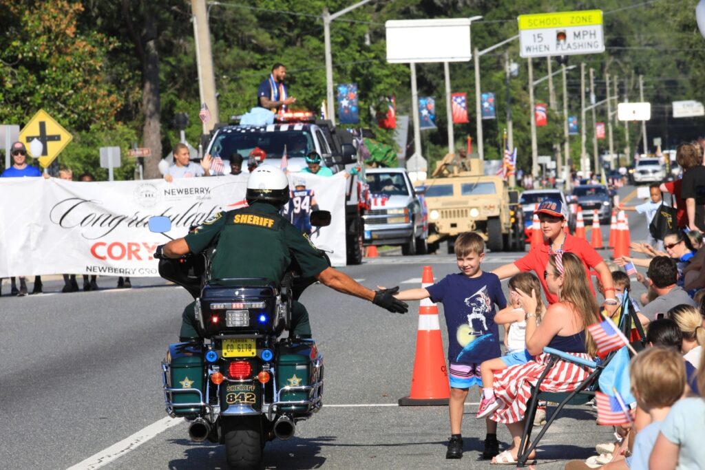 An Alachua County Sheriff's Office deputy gave high fives to kids ahead of the Newberry Fourth of July Parade.