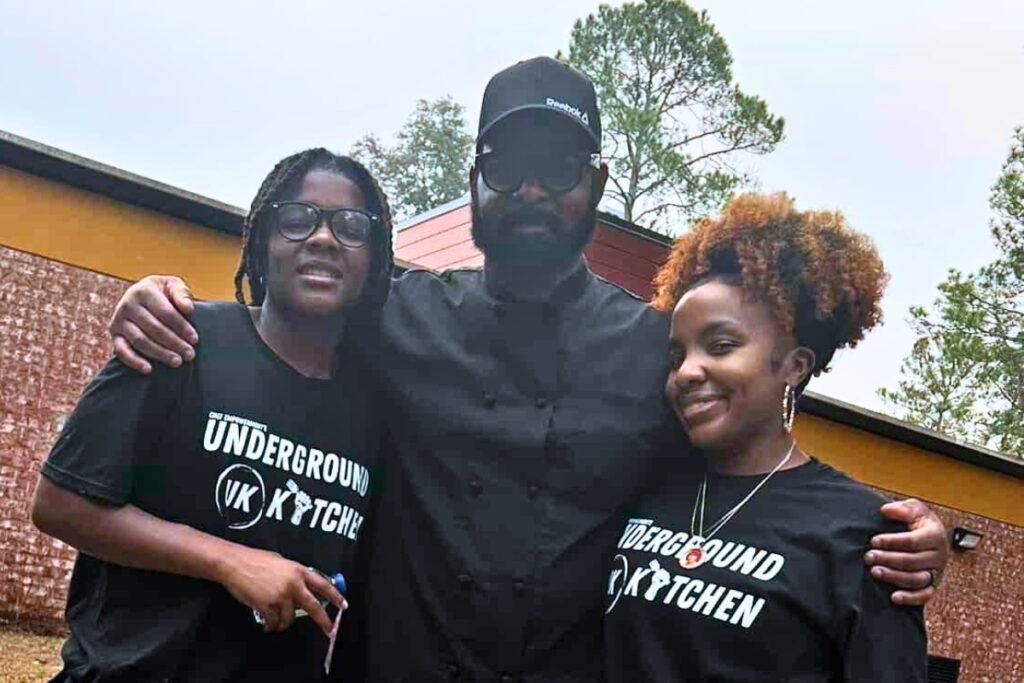 Chef Carl Watts (center) of Underground Kitchen and the Gainesville Housing Authority are partnering to open the first community kitchen in East Gainesville. Courtesy Underground Kitchen