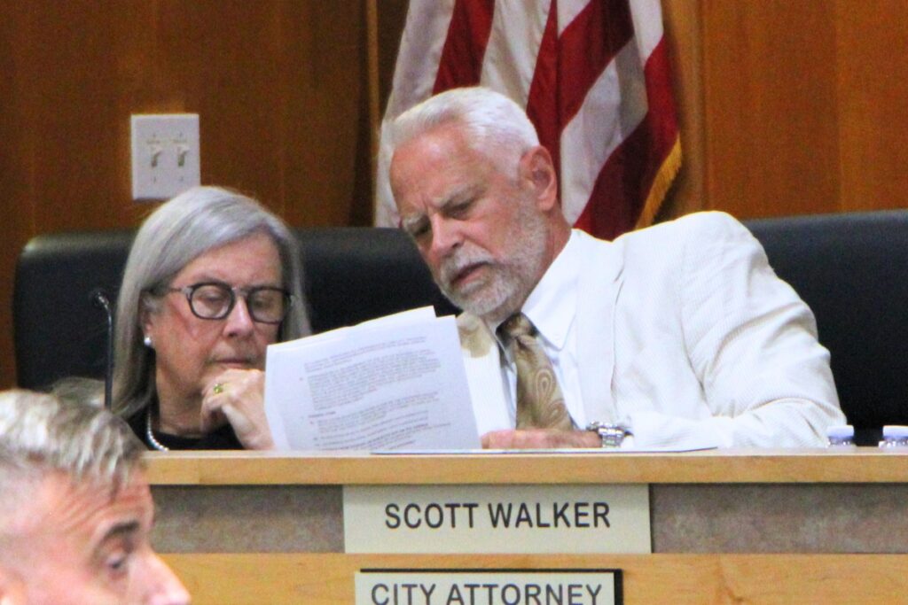 City of Alachua's land use attorney Patrice Boyes (left) and City Attorney Scott Walker deliberate during a rezoning hearing for Farmlands Commercial. Photo by Lillian Hamman