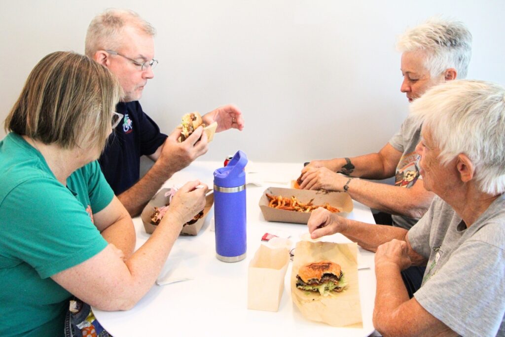 DJ’s dedicated customers Lori Sandholdt (far left), Marc Branham (second from left), Angie Mulkin (back right) and Shorty Knowles (front right) have frequented the burger joint for years.