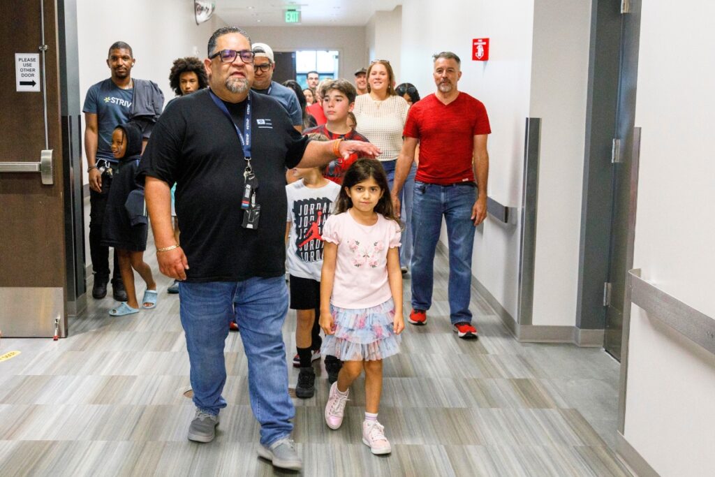 Employees lead family members through Strive Pharmacy's manufacturing facility during Family Day in Alachua on July 24. Photo by Walker Smith