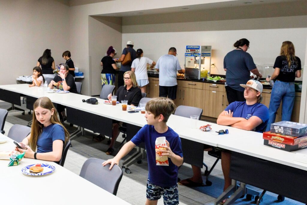 Families gather for food and a movie before touring Strive Pharmacy's manufacturing facility during Family Day in Alachua on July 24. Photo by Walker Smith
