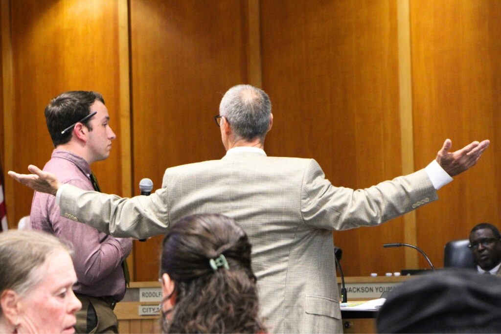 Gary Pappas (right) cross examines city of Alachua Principal Planner Carson Crockett about soil hydrogeological testing for the Farmlands Commercial development. Photo by Lillian Hamman