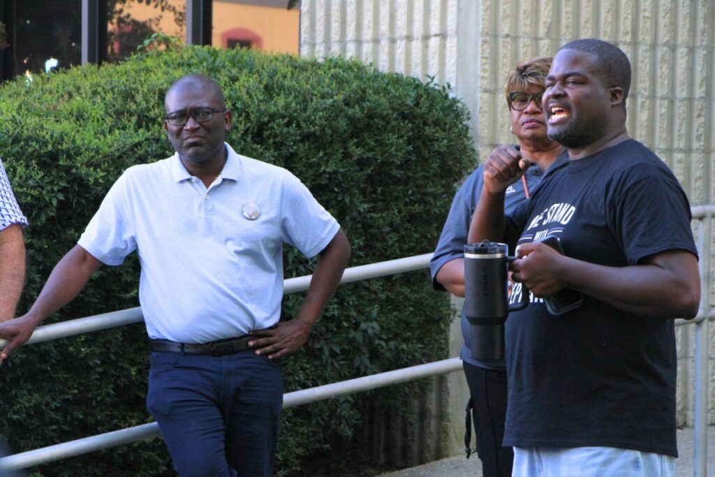 High Springs Police Officer Adam Joy (right) led a prayer meeting on behalf of Police Chief Antoine Sheppard (left) following his reinstatement. Photo by Lillian Hamman