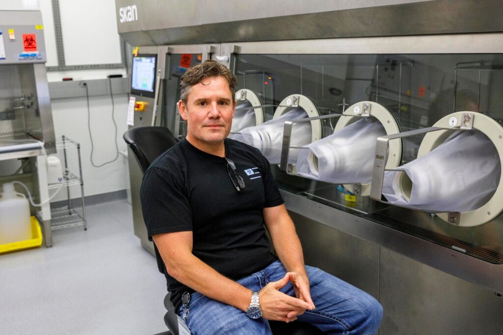 Jason McGuire, senior vice president of operations, poses for a portrait surrounded by high tech manufacturing equipment. According to McGuire, every employee has a minimum of 10 years experience.
