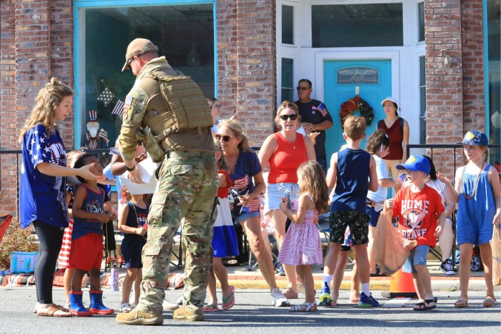 Kids line up for candy from parade participants. 