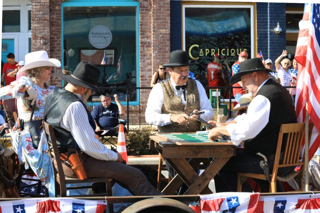 The Shadow Riders sit around a poker table to represent old western history. 