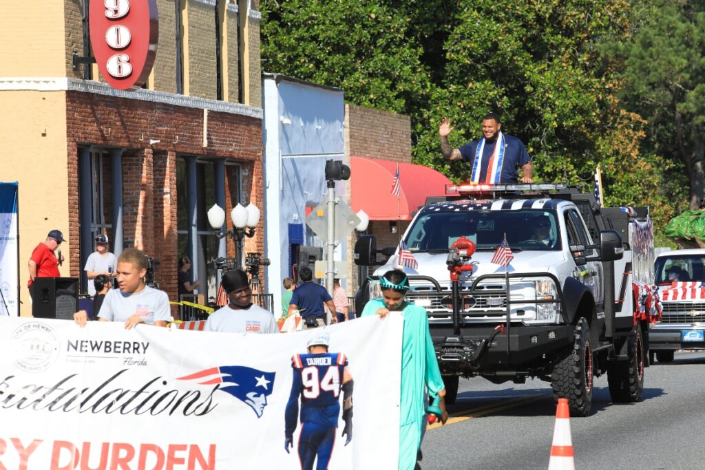 The first floats of the Newberry Parade of 100 American Events and Inventions, with Grand Marshal Cory Durden in the lead vehicle. 