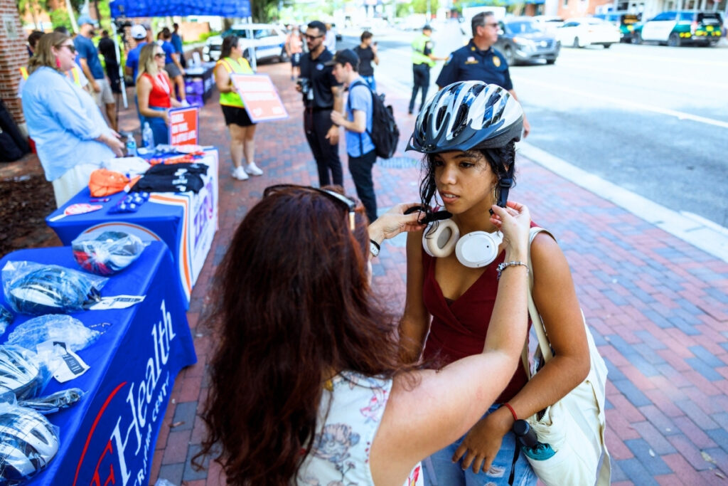 A UF student gets fitted for a bike helmet. Photo by Walker Smith