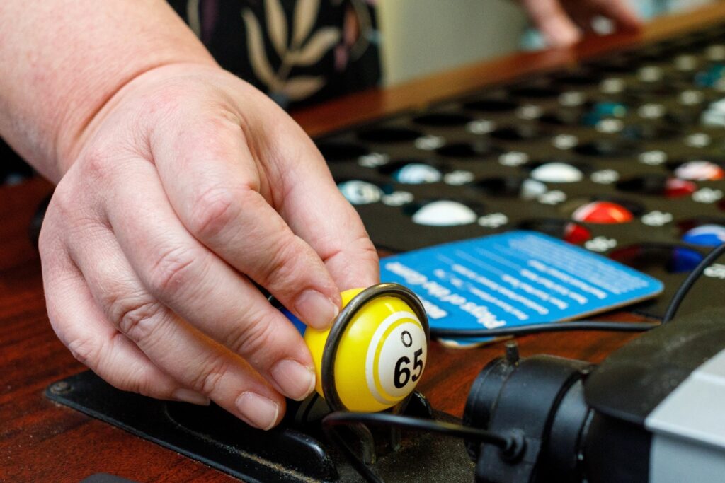 A bingo caller reads numbers from bingo balls as they funnel through a machine during a Sunday afternoon game at Veterans of Foreign Wars Post 2811 off Waldo Road in Gainesville.