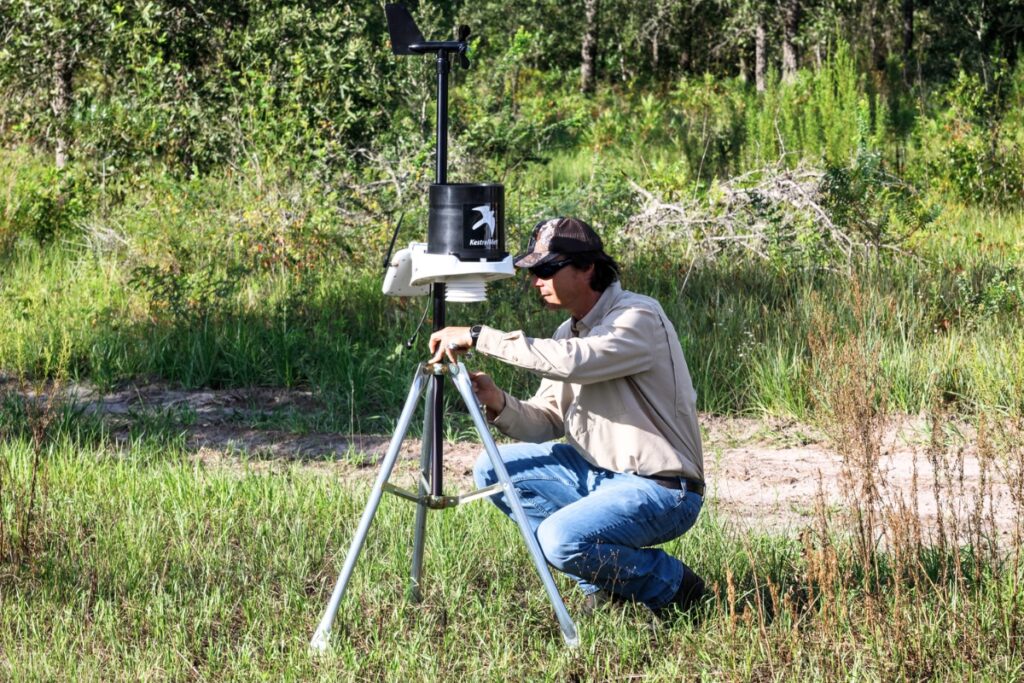 A portable weather monitoring station records rainfall and other environmental conditions on a newly acquired University of Florida IFAS property near Parker Road. The data helps Cully Lord determine when conditions are suitable for prescribed burns.