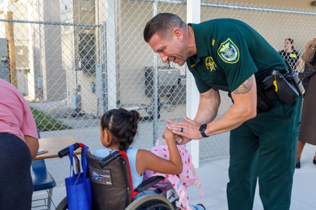 Alachua County Sheriff’s Office Capt. Chris Sims greets students and parents on the first day of school at Oak View K-8 School on Monday, Aug. 10, 2026. “When you live in a town of 10,000 people, you get to know pretty much everyone,” Sims said.
