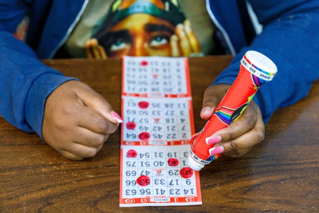 Bingo players use 'daubers' to mark each number as it is called during a Sunday afternoon game at VFW Post 2811 in Gainesville, Florida. Bingo cards start at $25, with higher-priced cards offering