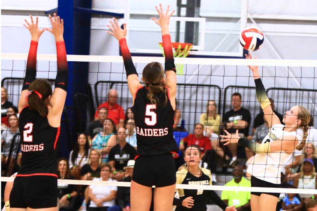 Buchholz's Lily Vaillancourt (5) with a hit against Santa Fe's Emarie Carlisle (2) and Ella Schneider (5) at the Crafty Gemini Preseason Showdown on Thursday. Photo by C.J. Gish